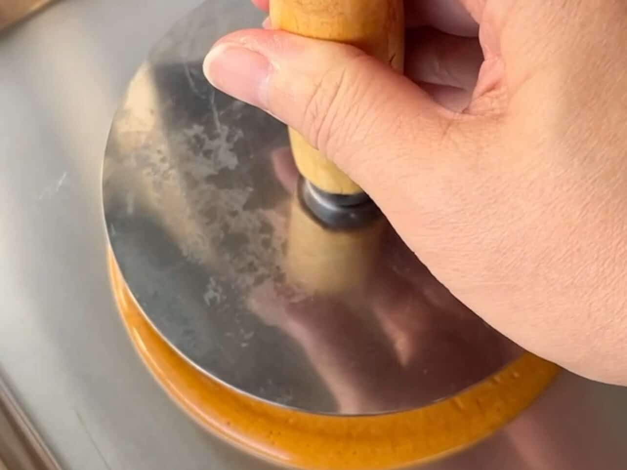 Press cookie cutter down using hotteok press