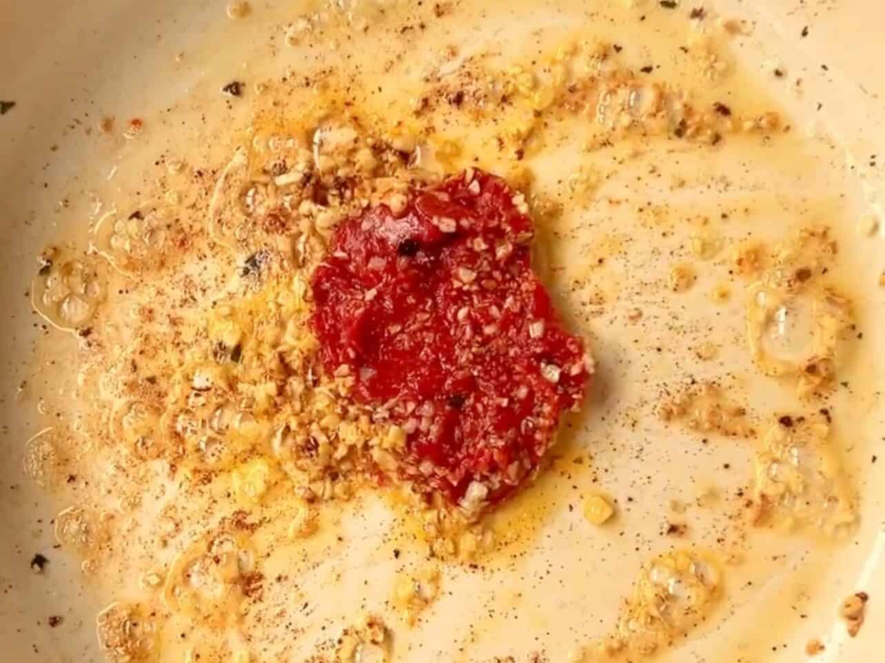 saute garlic and tomato sauce in the same pan
