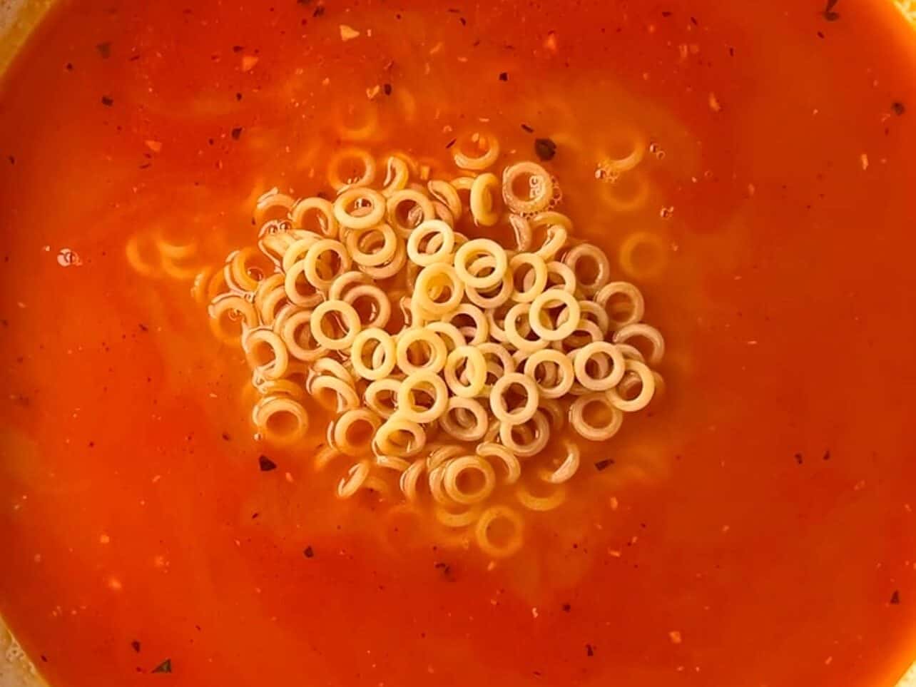 Add broth and spaghettiOs pasta to pan