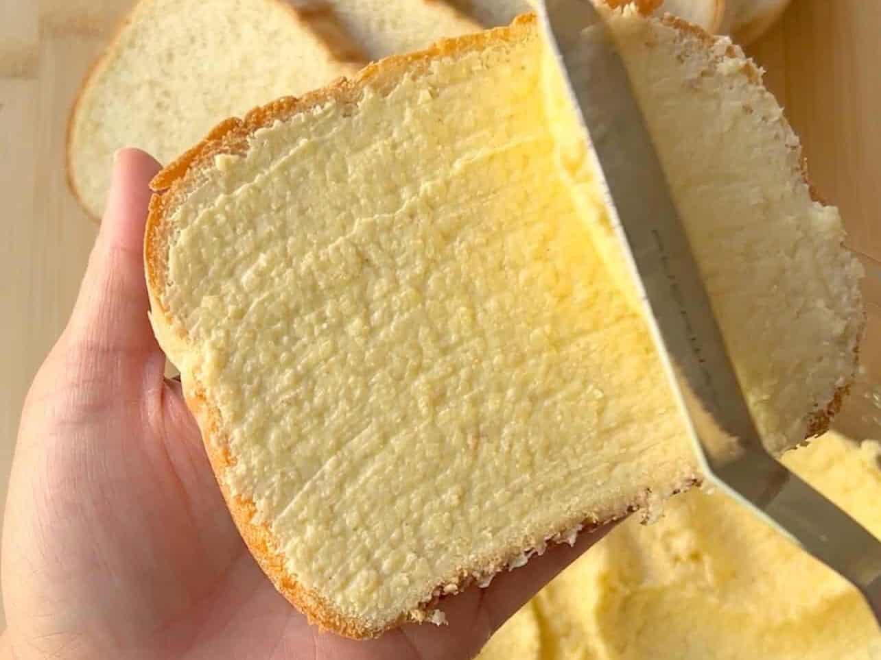 slather cheese butter on slice bread