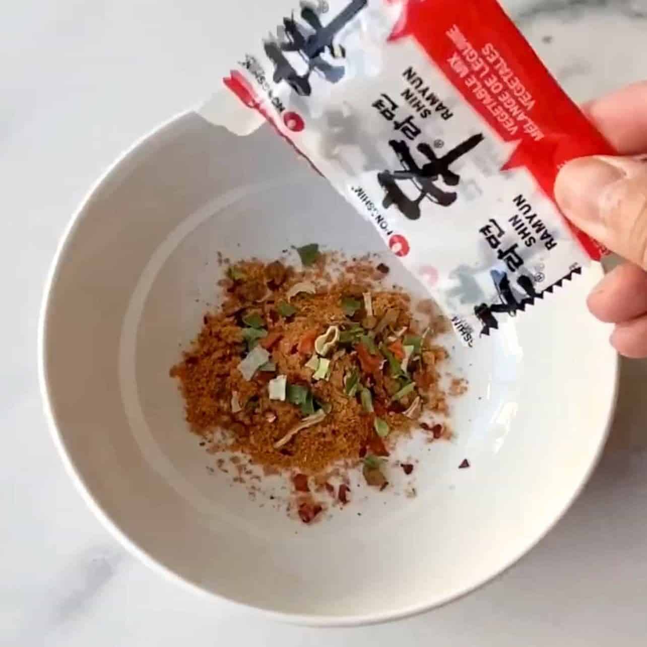 add ramen seasoning packets to bowl