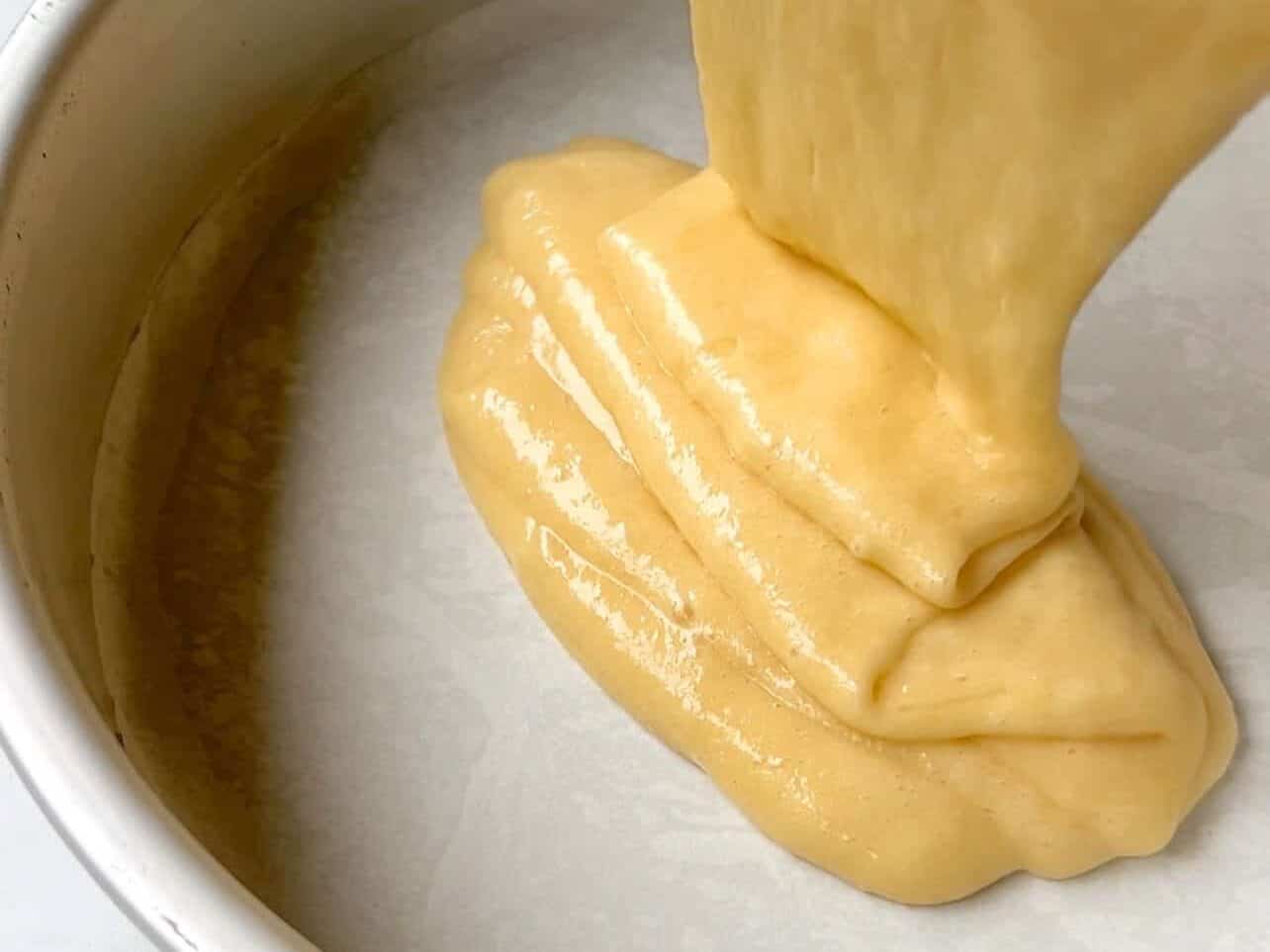 Pour cake batter into greased lined pans