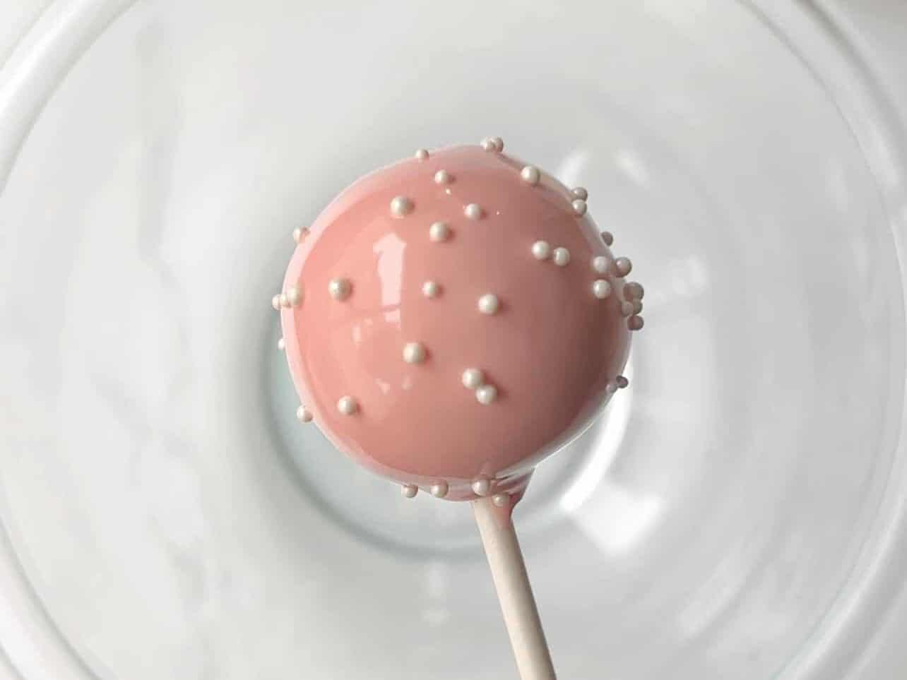 Sprinkle nonpareils to birthday cake pops quickly