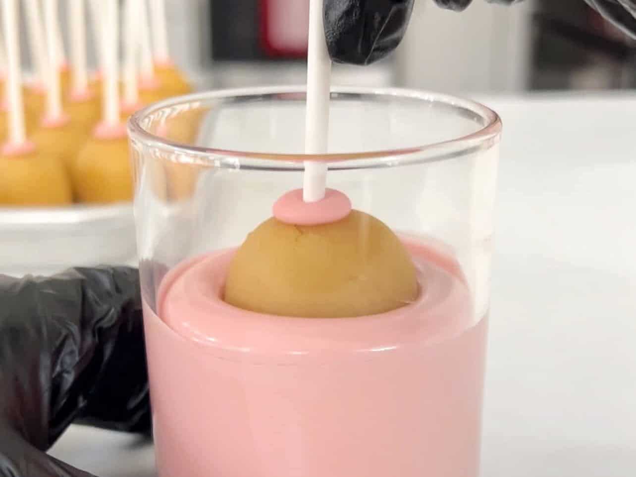 Dunk and coat Starbucks copycat birthday cake pops in candy melt