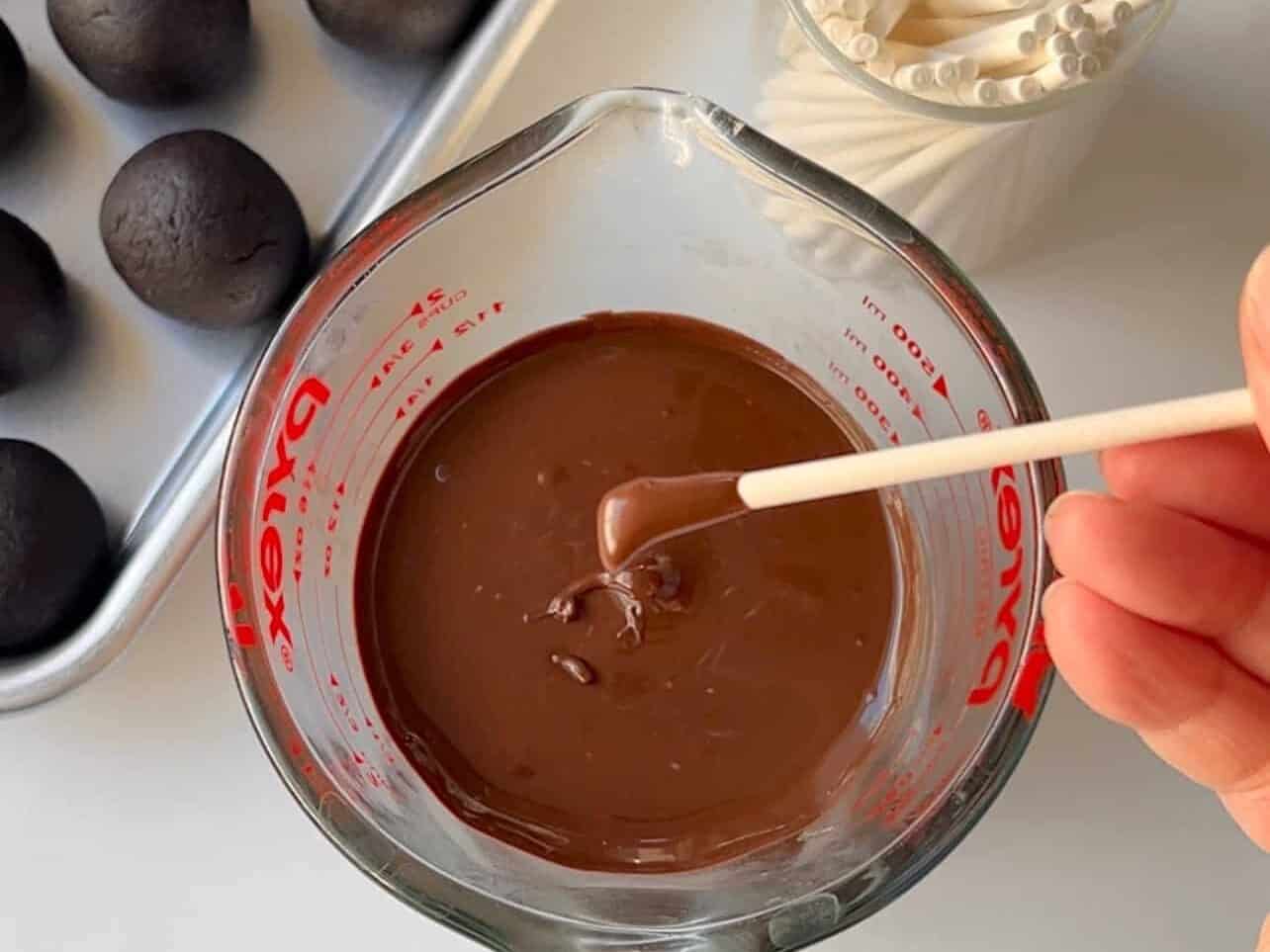 dip cake pop stick into candy melt