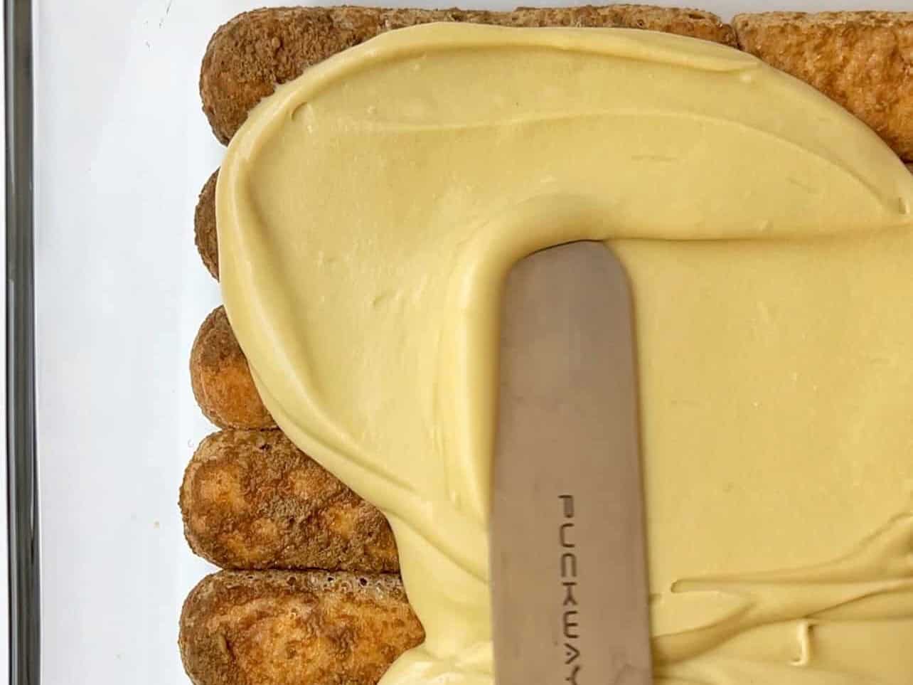 spread first layer of pistachio filling for tiramisu