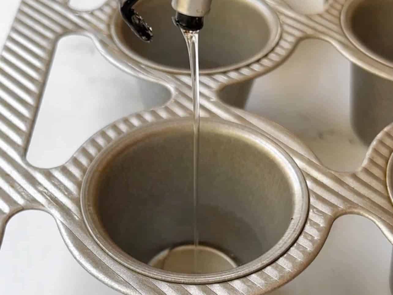 add oil into each compartment of popover pan