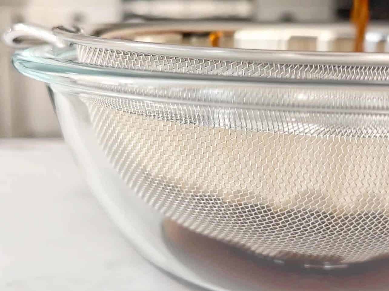 filter vanilla specks using coffee filter and sieve