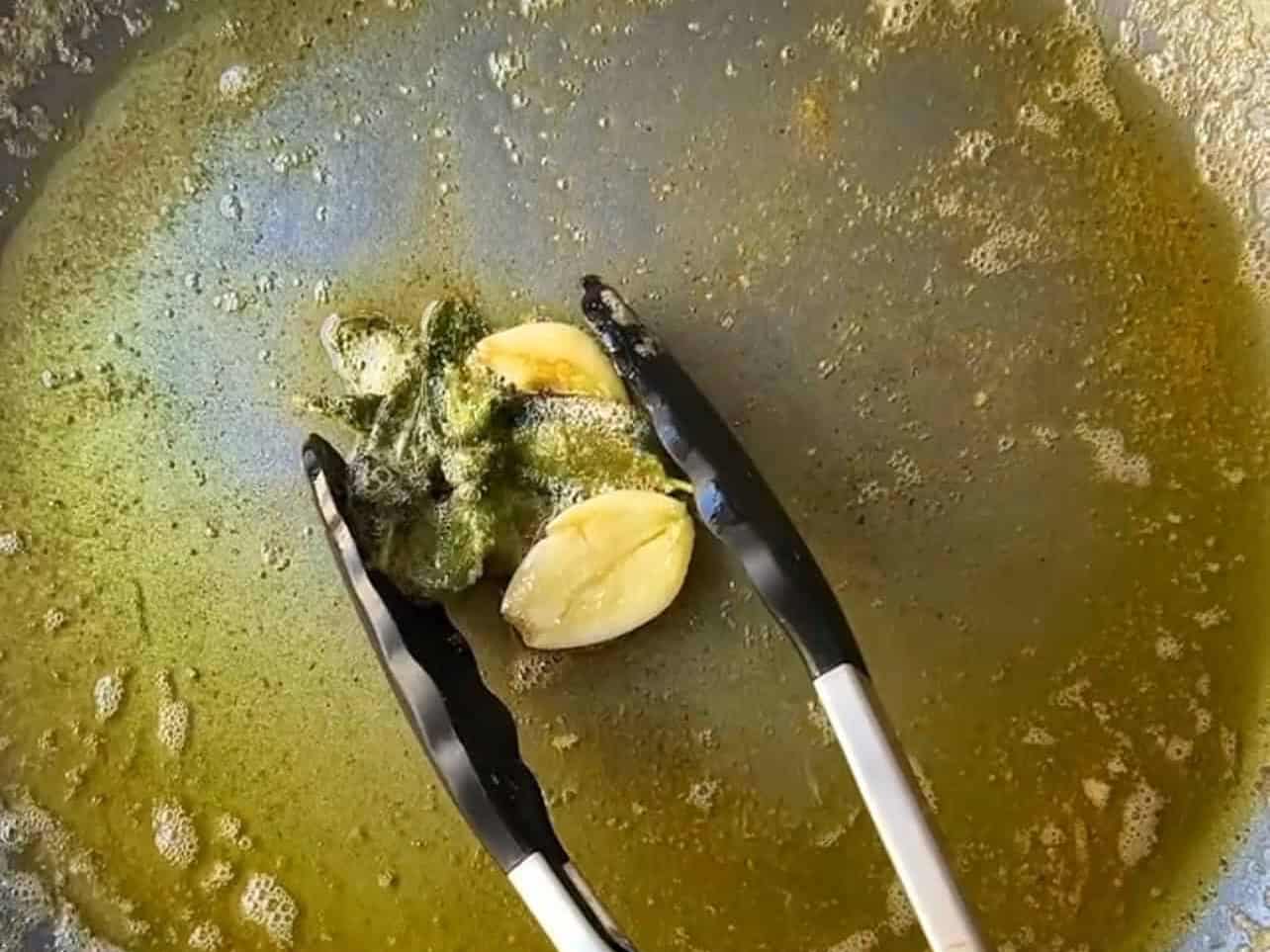 turn off stove heat and remove garlic and sage leaves from pan