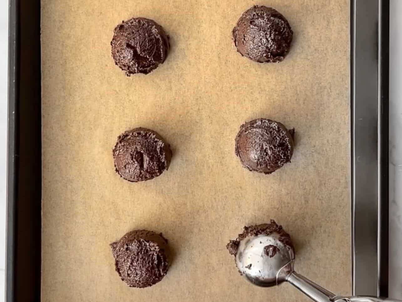scoop brownie cookie dough onto baking sheet
