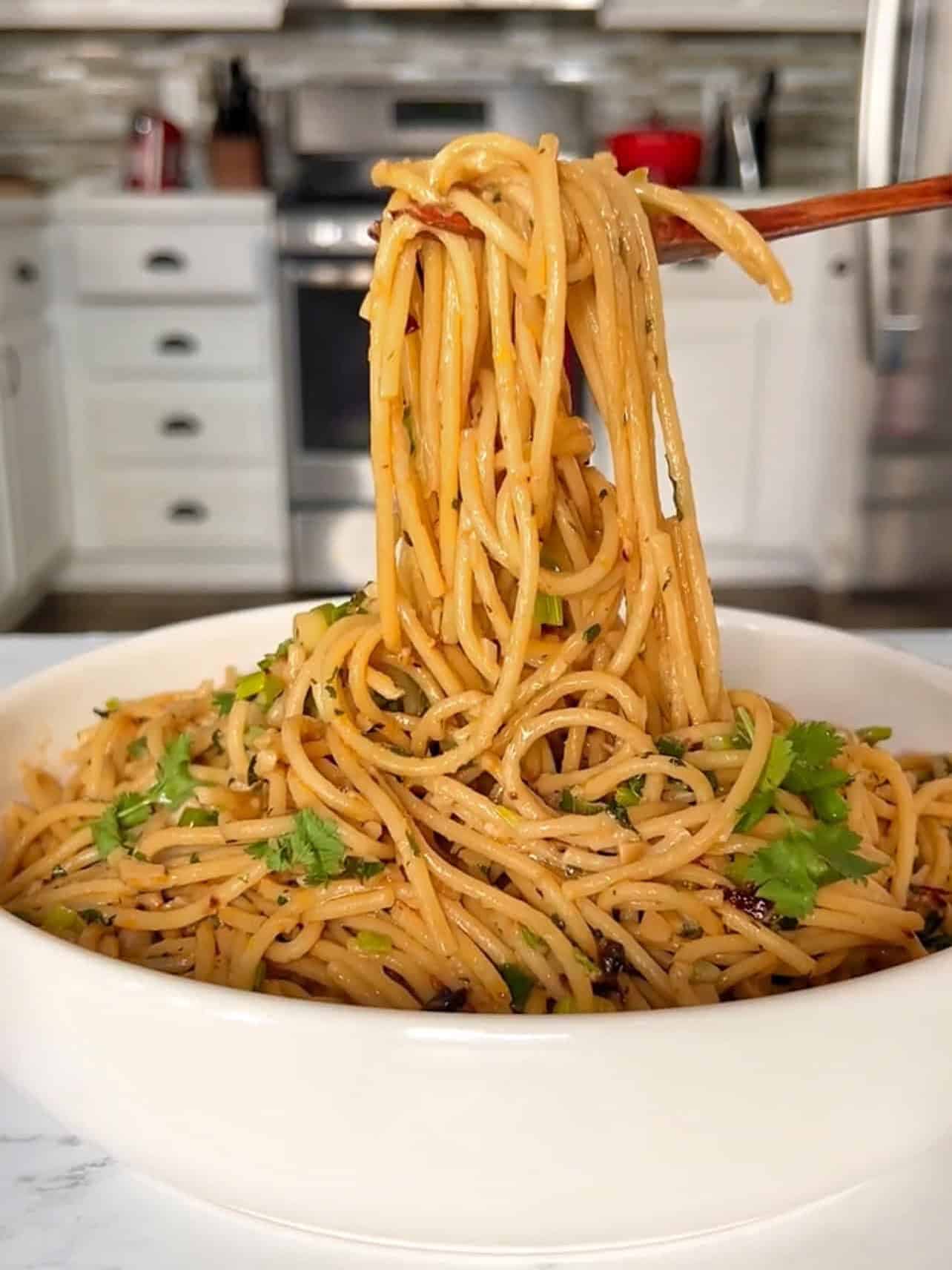taking a bite of garlic butter chili crisp pasta
