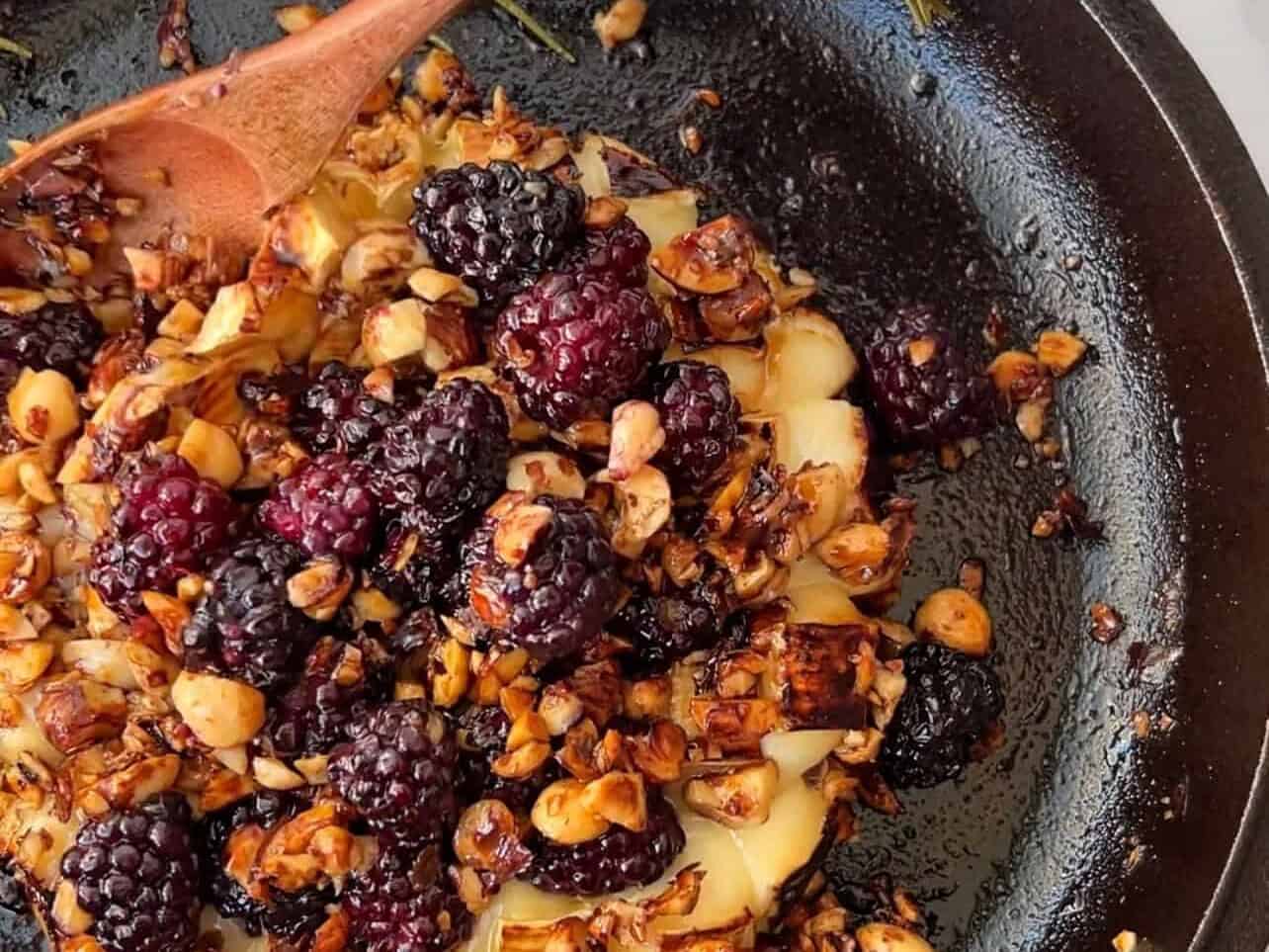melted baked brie with blackberries, hazelnuts, and rosemary