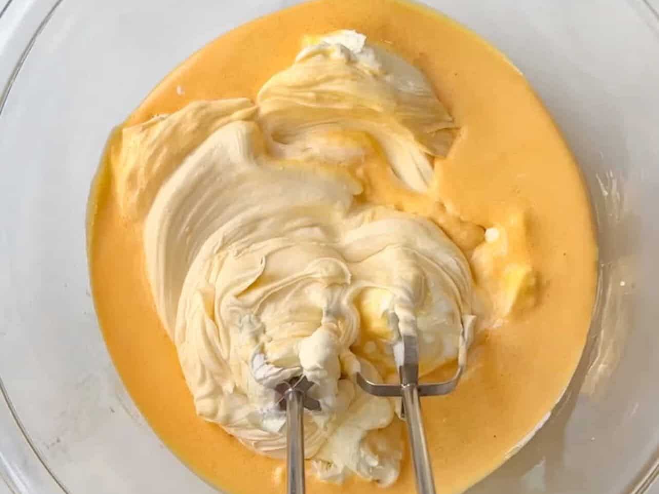 combining eggs and sugar with mascarpone cheese