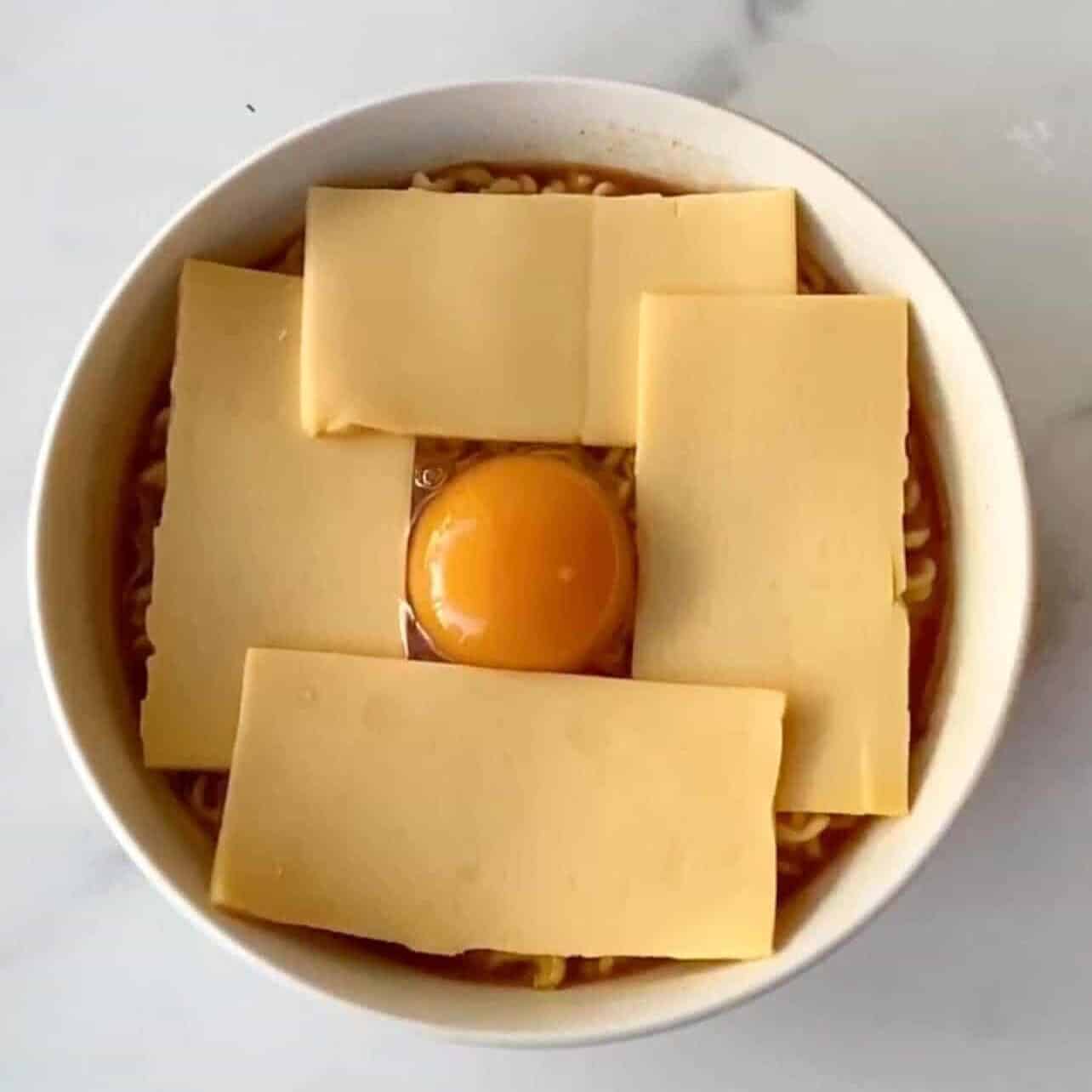 split cheese slices into two and add on top the ramen