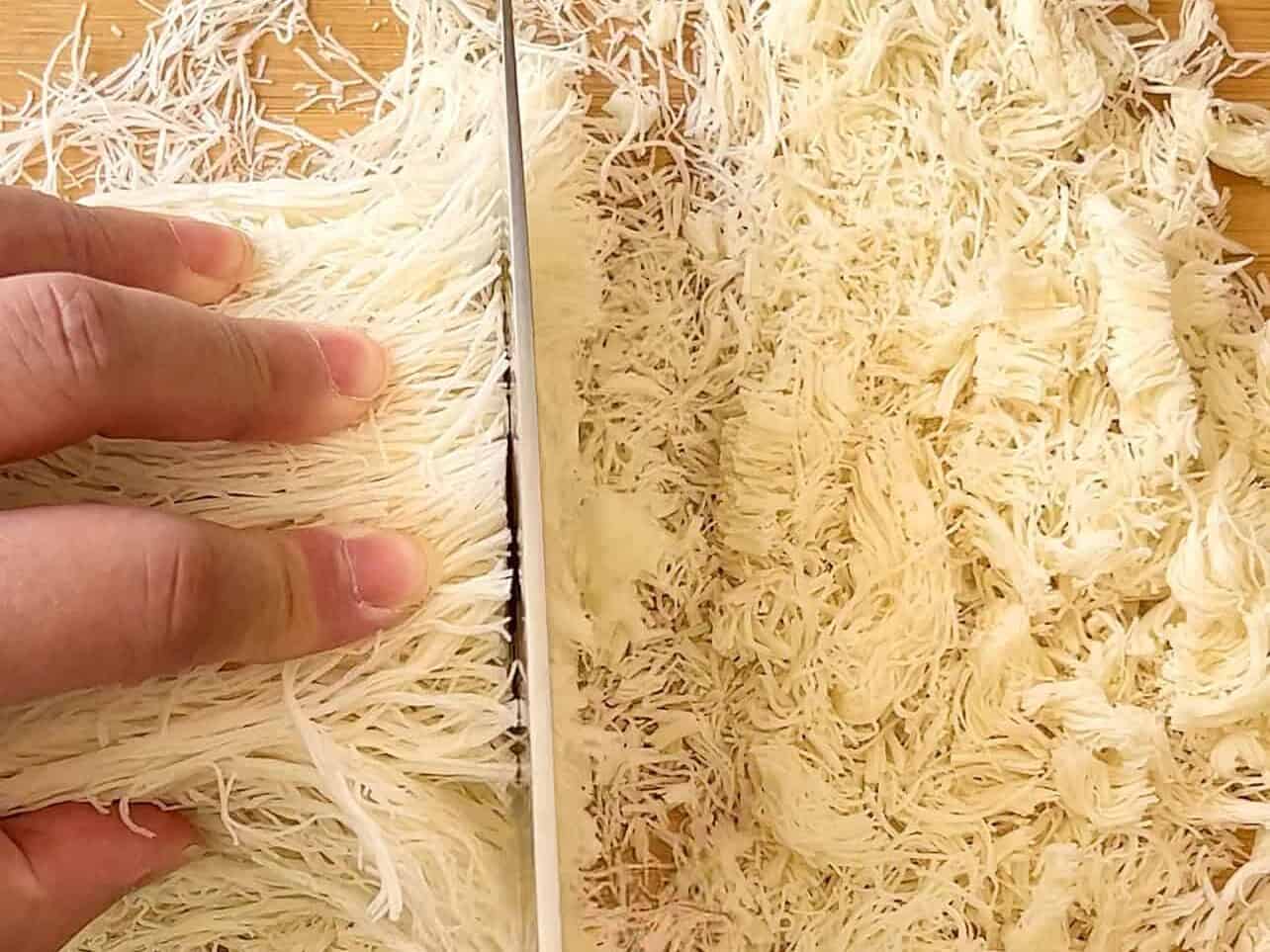 chopping kataifi shredded dough with a knife