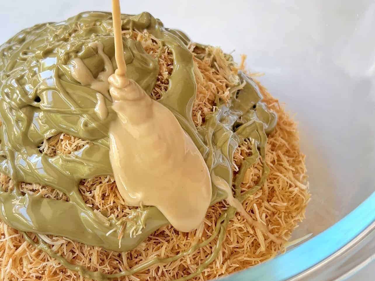 mixing toasted kataifi with pistachio cream and tahini