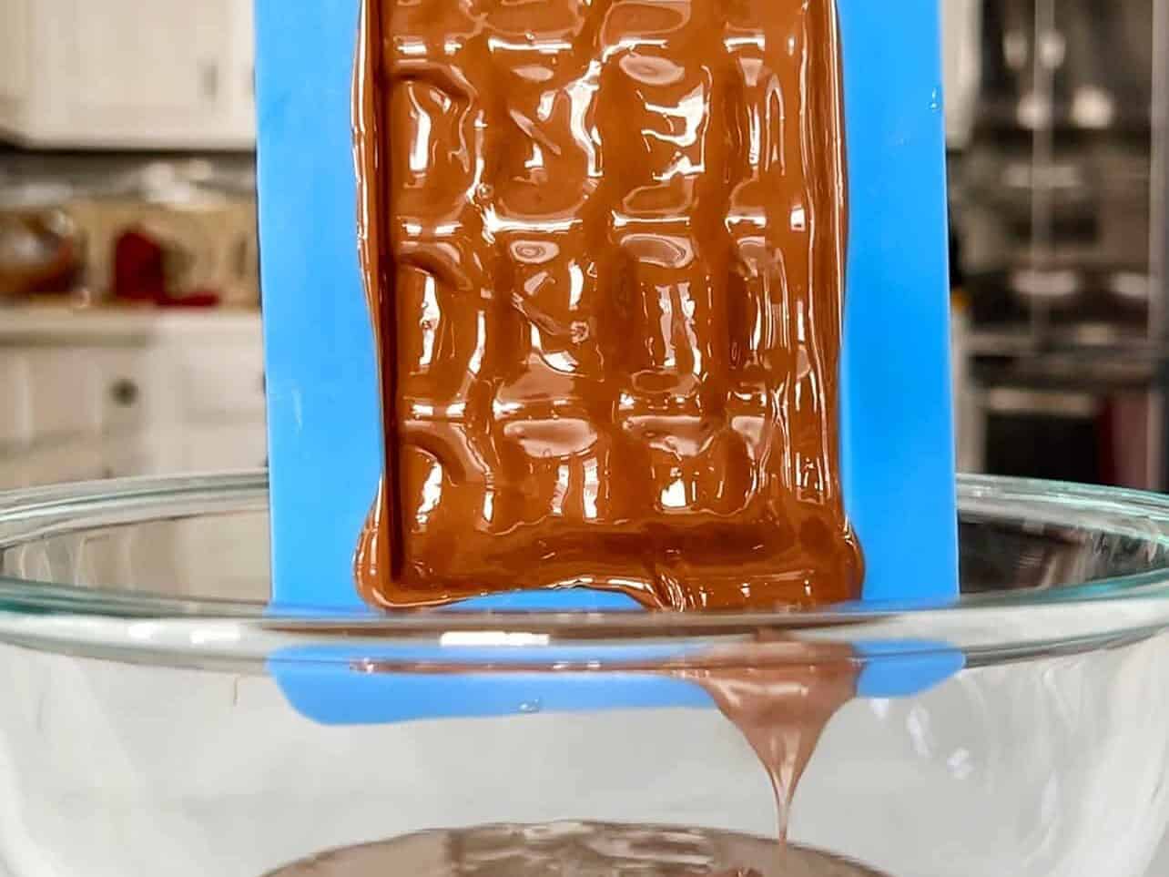 excess chocolate drips from mold