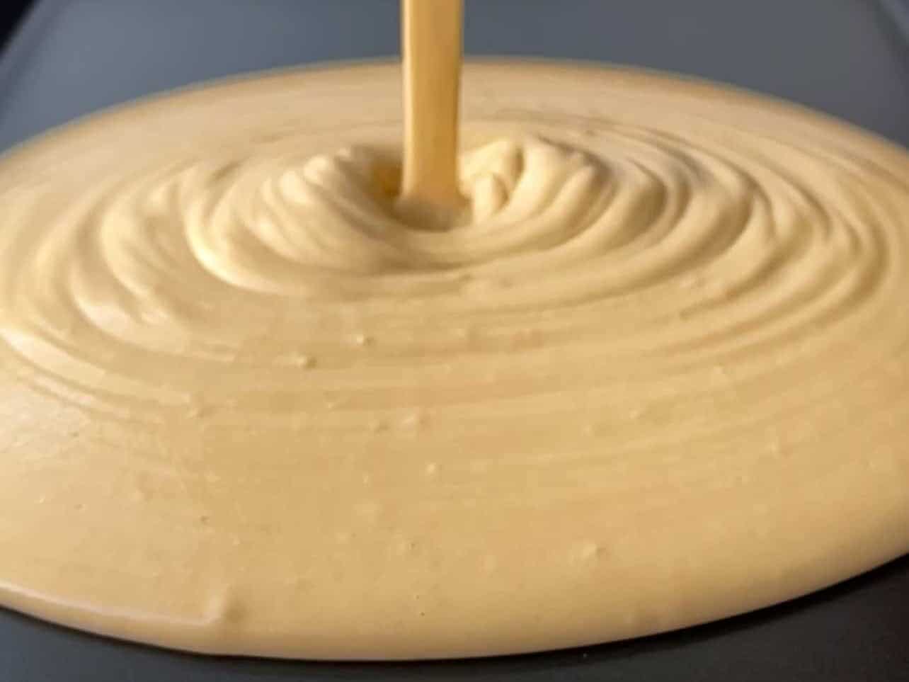 pour pancake batter onto greased pan