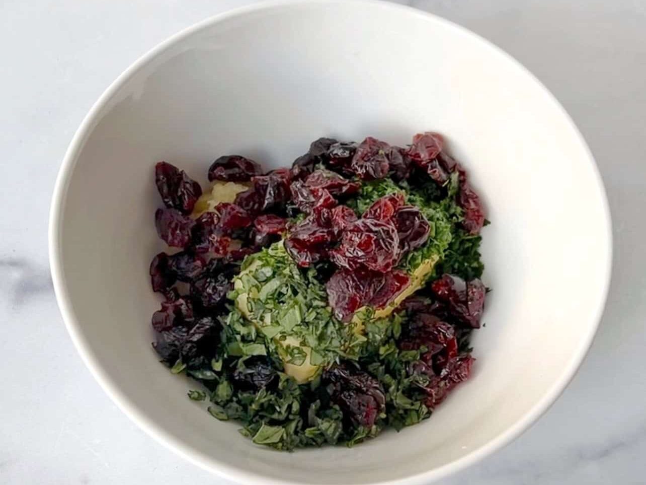 combine herbs, butter, and cranberries to make cranberry herb butter