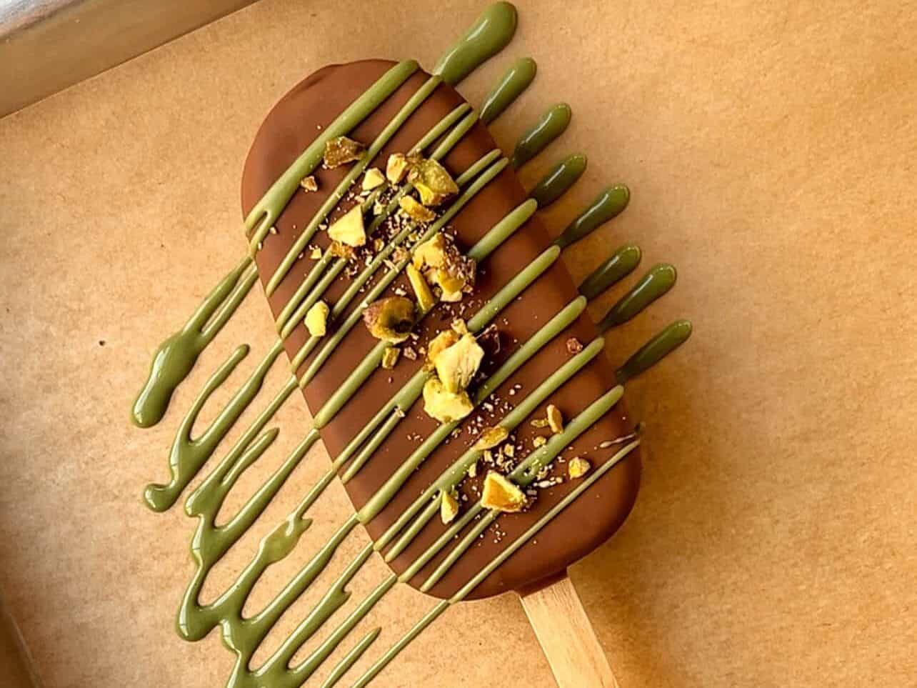 drizzle green chocolate onto ice cream bar and sprinkle chopped pistachios