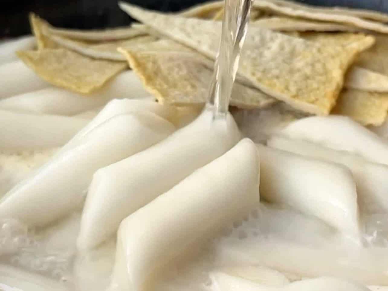 adding rice cakes, fish cakes, heavy cream, water to Rosé Tteokbokki