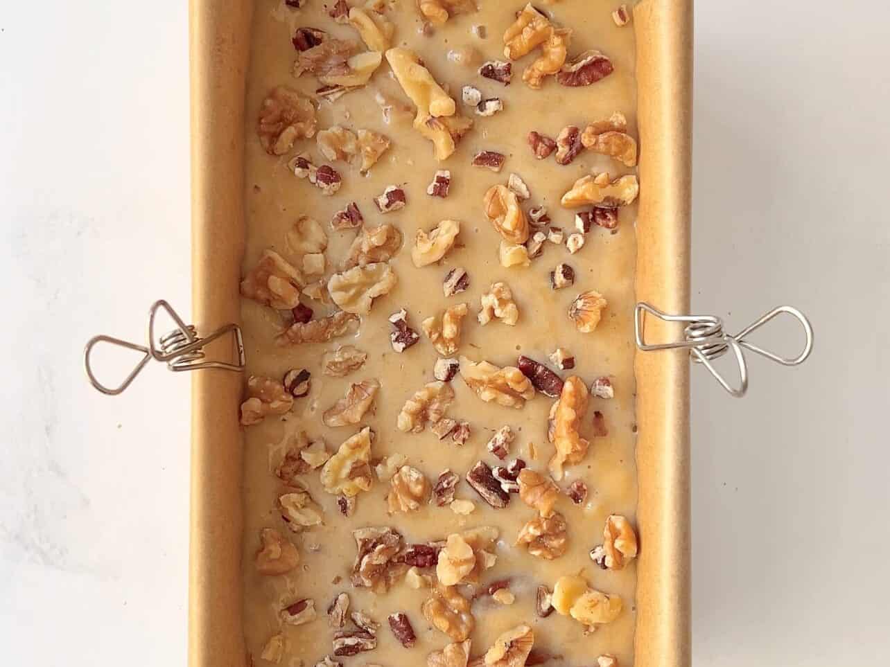 add banana bread batter to greased lined loaf pan