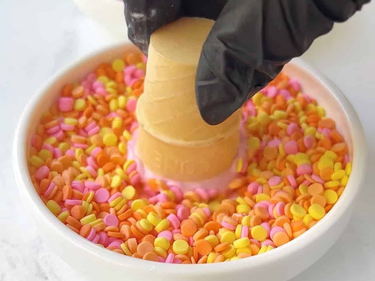 dip cone into bowl of sprinkles