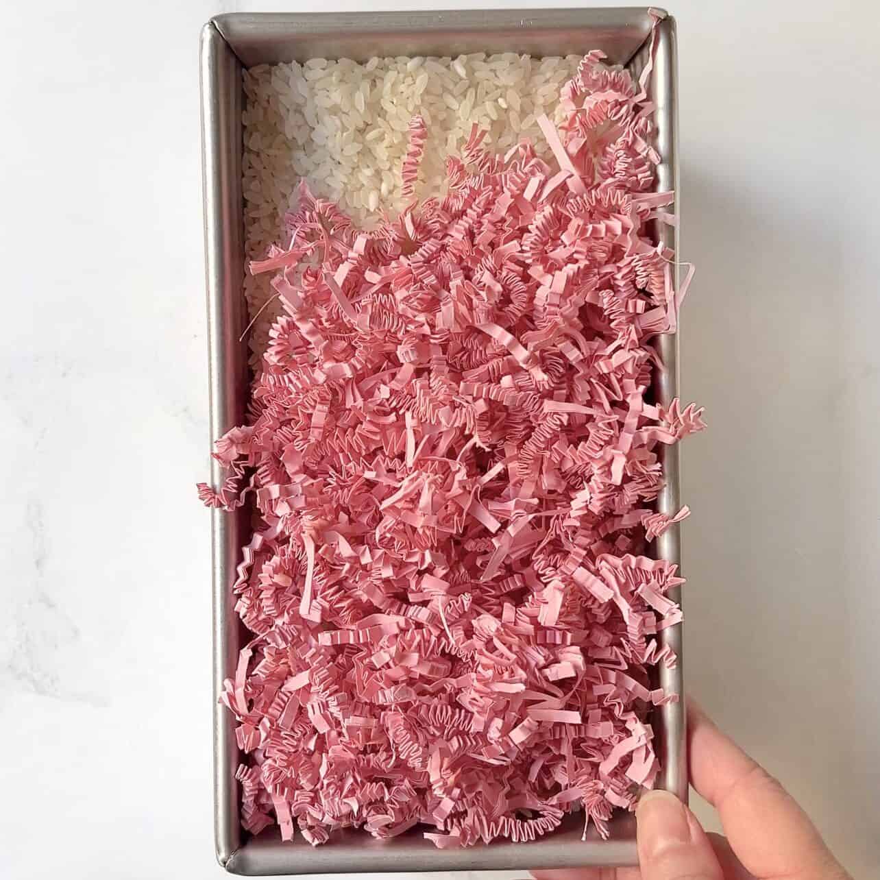 use deep loaf pan filled with rice for cake pop stand