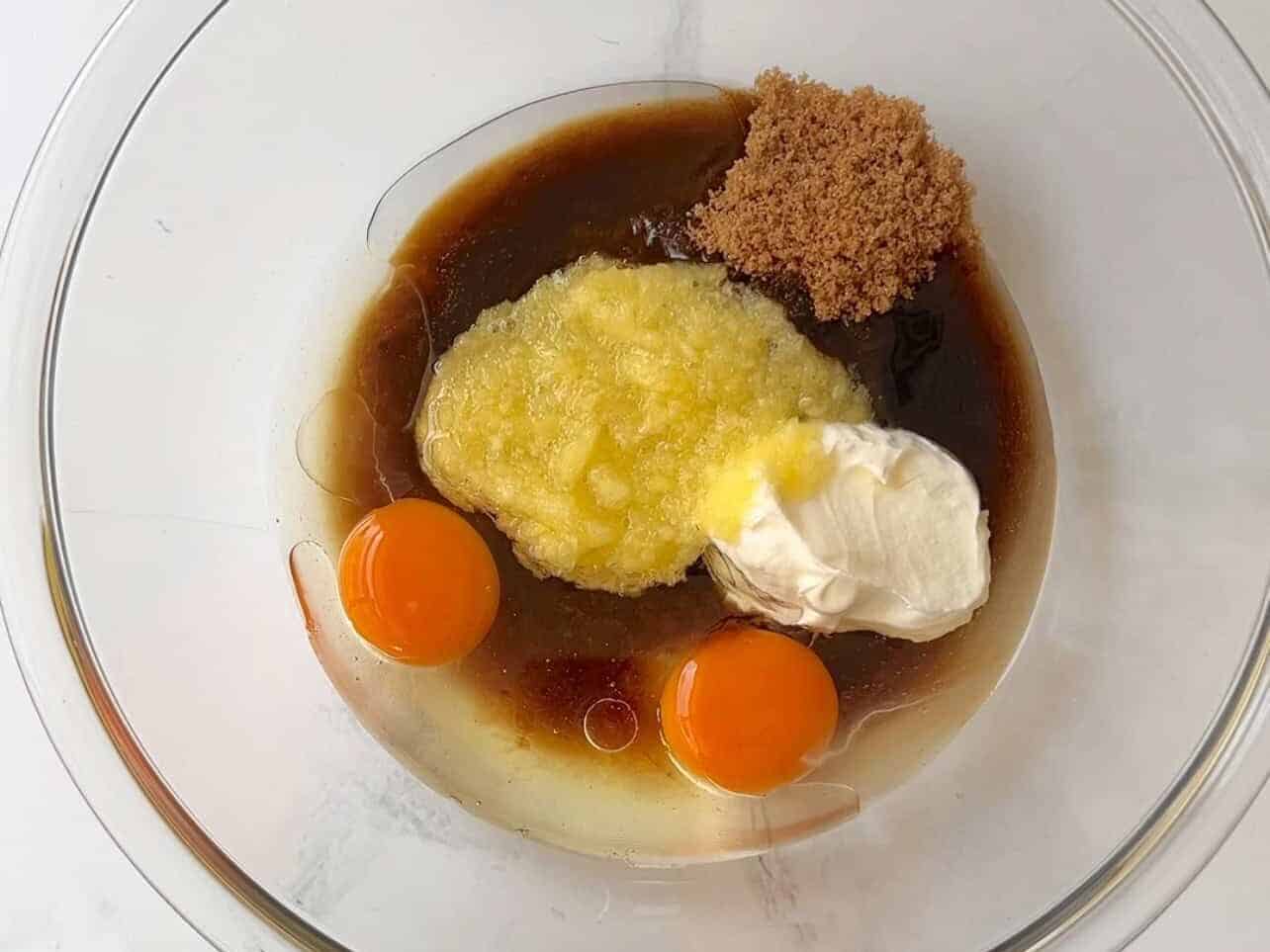 eggs, sour cream, oil, brown sugar, pineapple in a bowl to make carrot cake cupcake batter