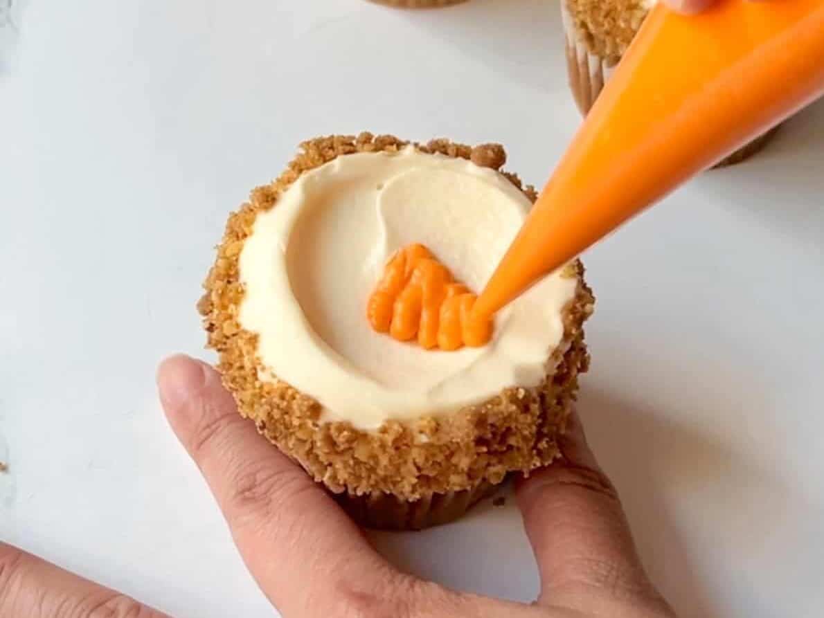draw carrot decoration onto carrot cake cupcake frosting