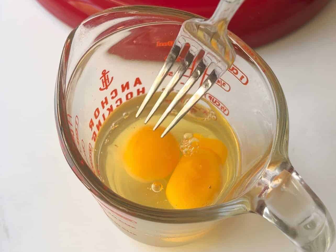 mix eggs in measuring cup