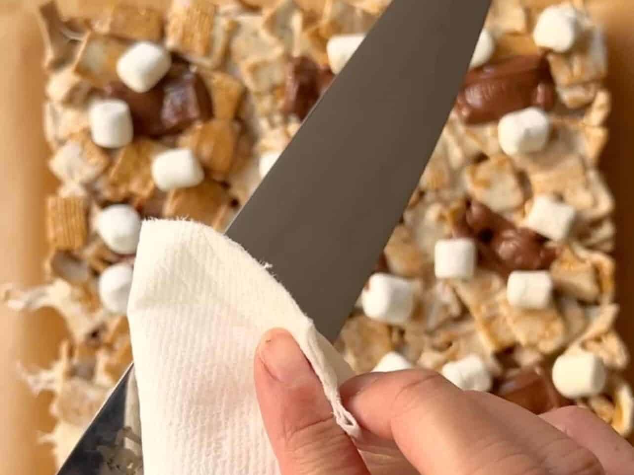 grease sharp knife to cut s'mores cereal treats to avoid marshmallows from sticking