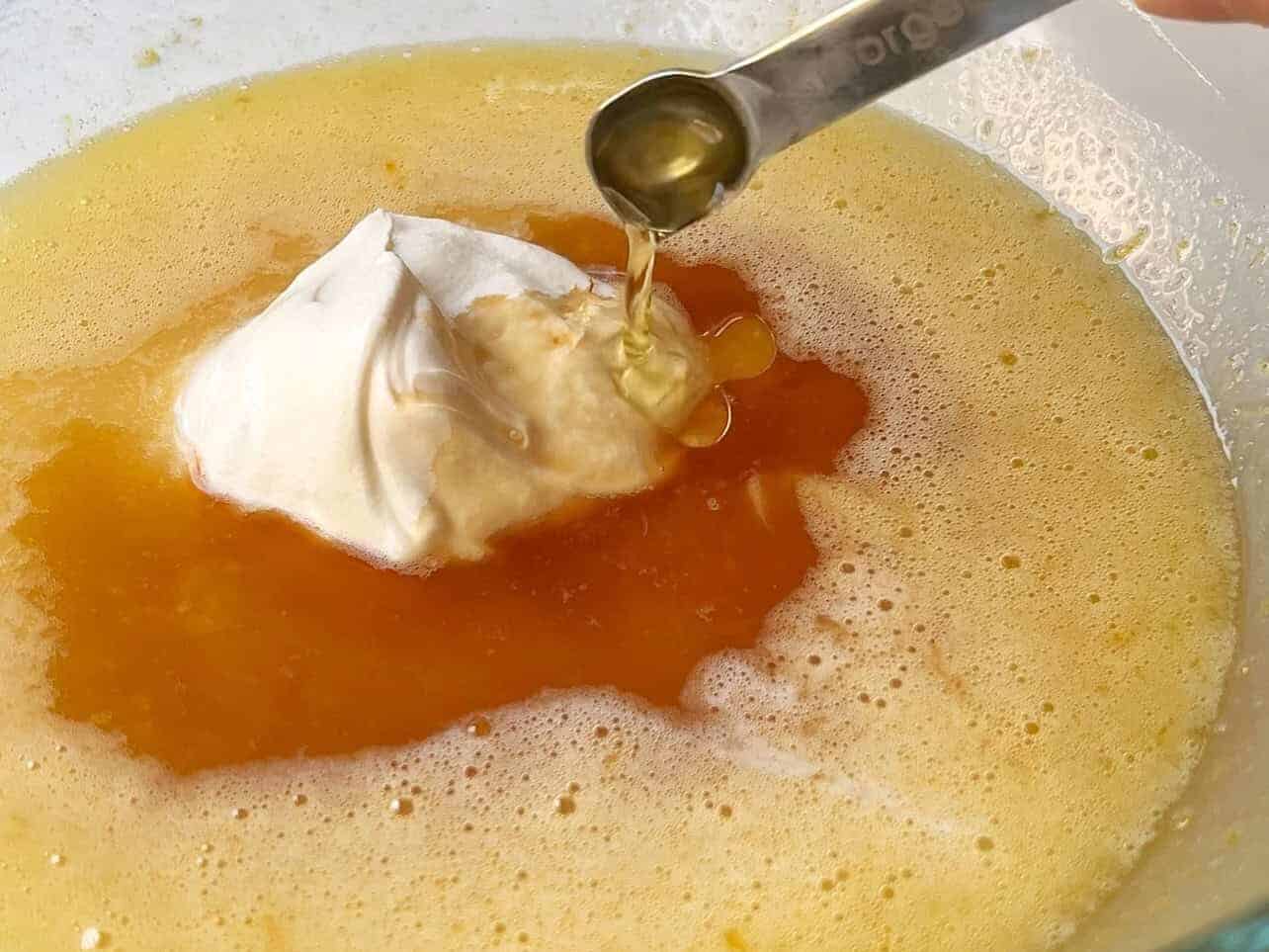 add vanilla and lemon extract, sour cream, and eggs to cupcake batter