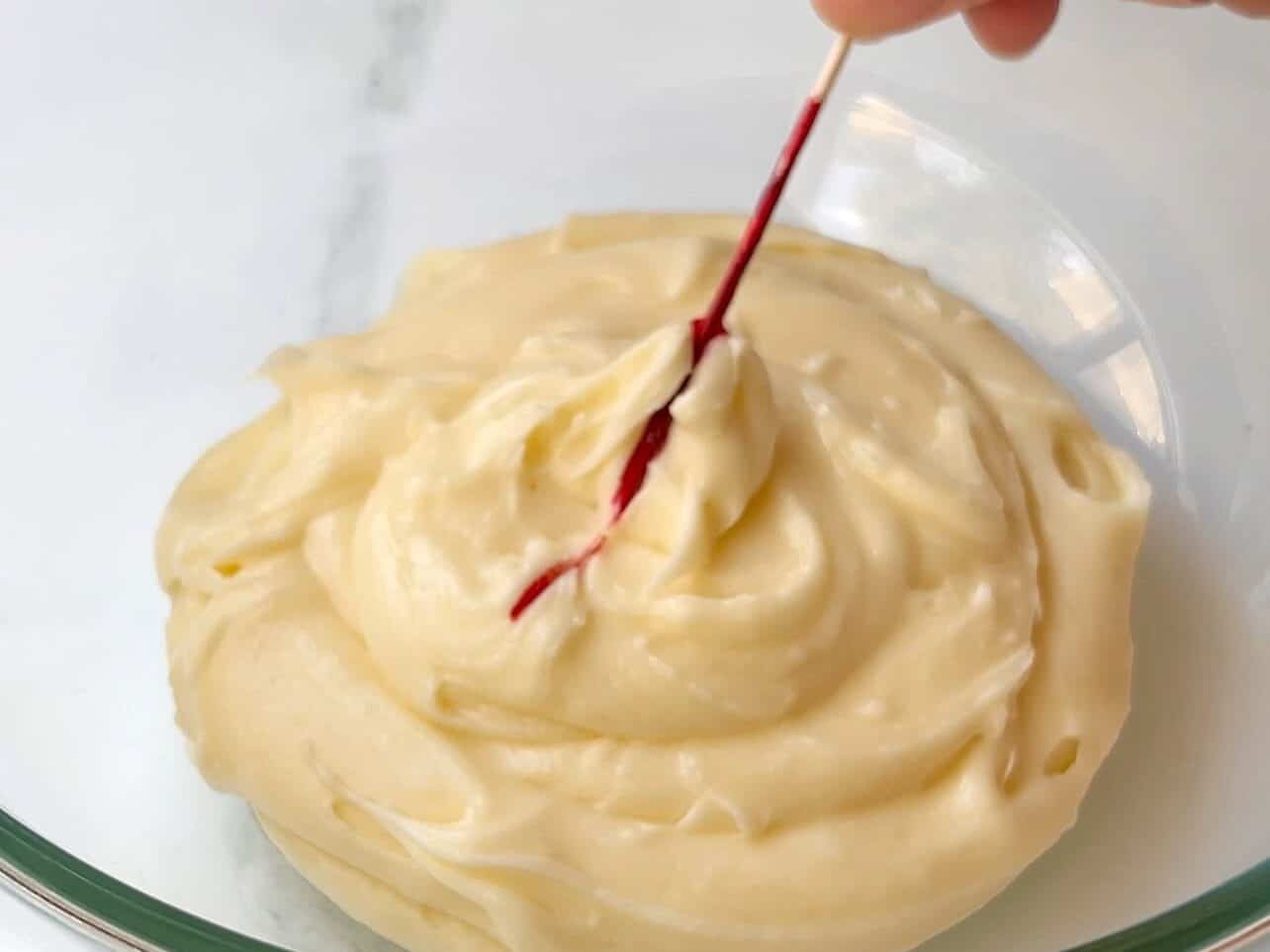 add streaks of pink gel food coloring to frosting