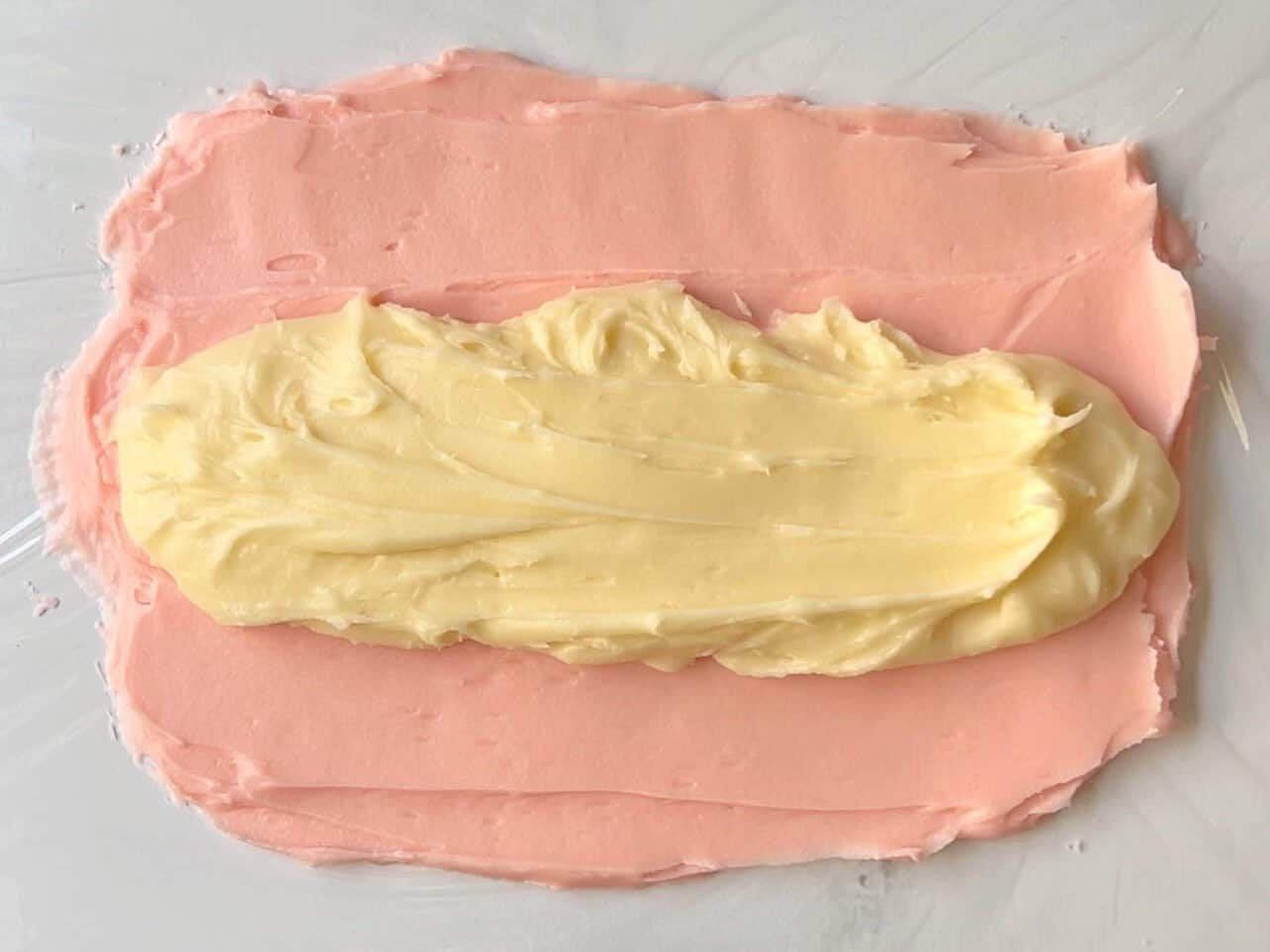 spread two colors of cream cheese frosting onto cling wrap to create two-tones