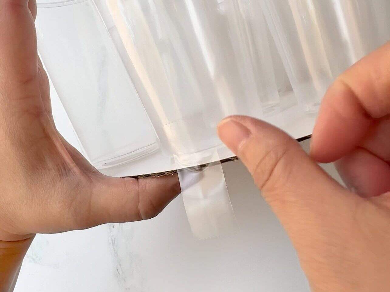 tape cups to round cake board to provide a base