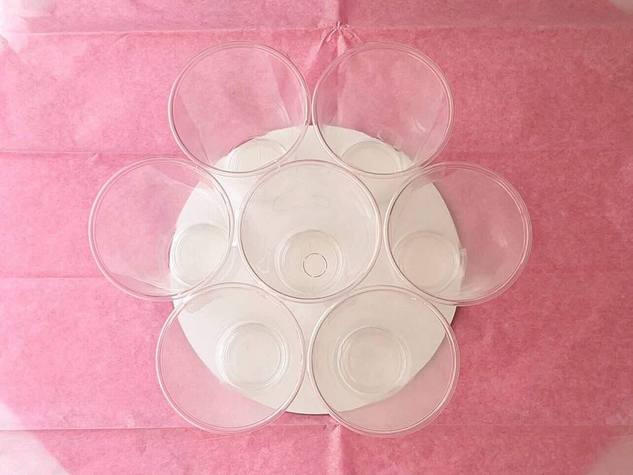 using cellophane, tissue paper, and cups to wrap a bouquet for cupcakes