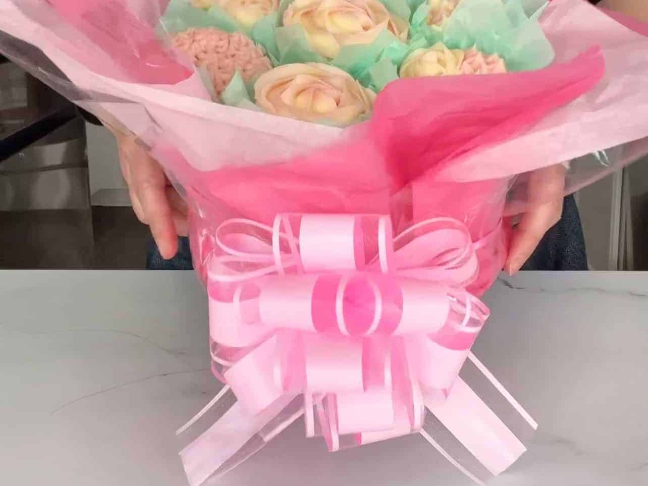 finished pink cupcake bouquet with large pink decorative bow