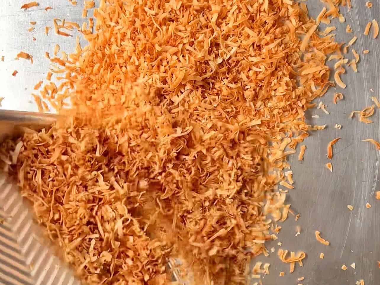 transfer toasted coconut flakes to cool pan to prevent burning