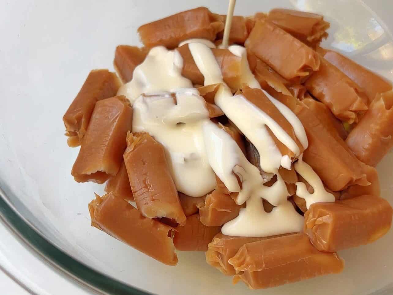 combining heavy cream with unwrapped caramel squared to make easy caramel sauce
