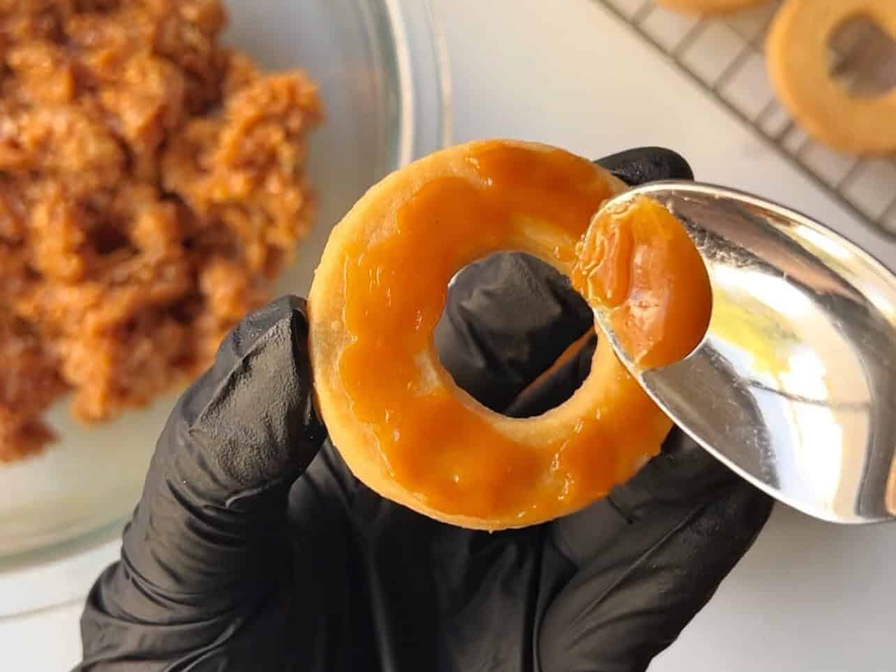 spreading caramel onto shortbread cookie ring