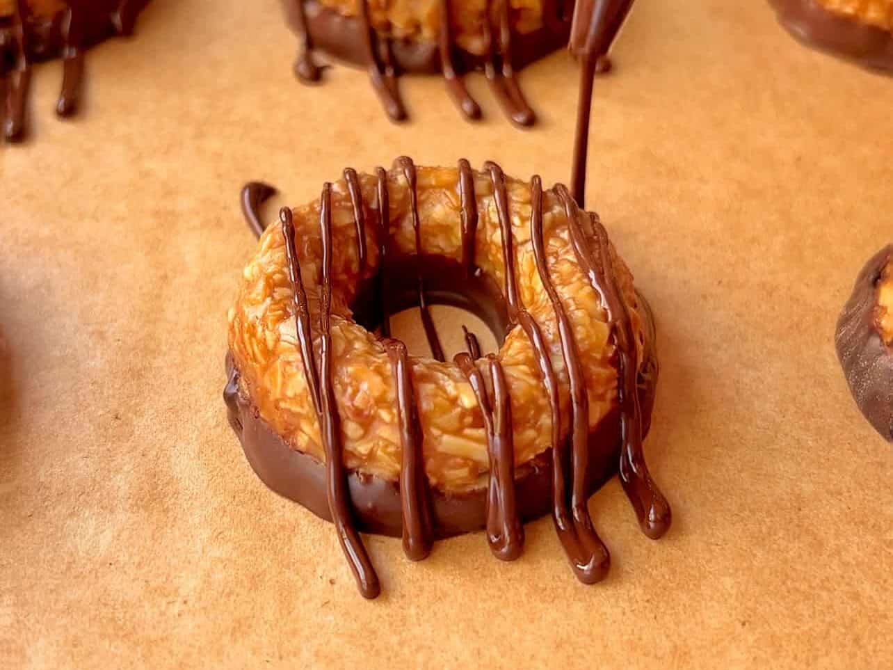 drizzle chocolate on top cookies to finish Girl Scouts Copycat Samoas cookie recipe