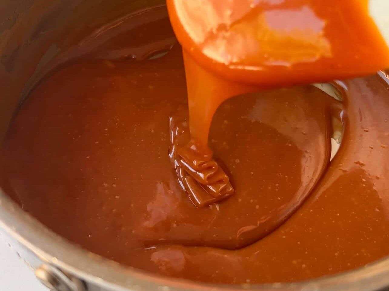 finished homemade caramel drizzling down in ribbon stage