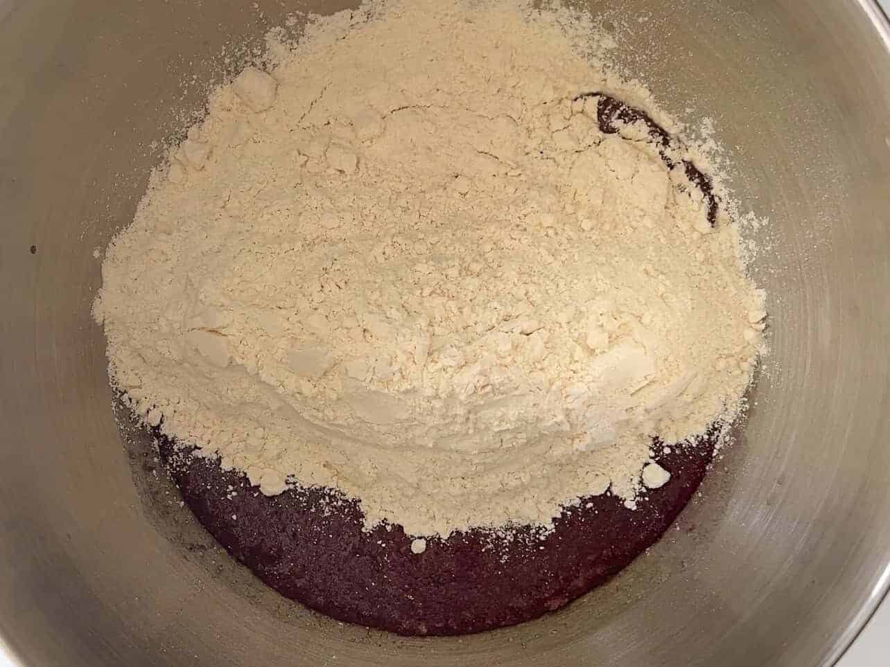 combining wet and dry ingredients to make ube coconut sweet rolls