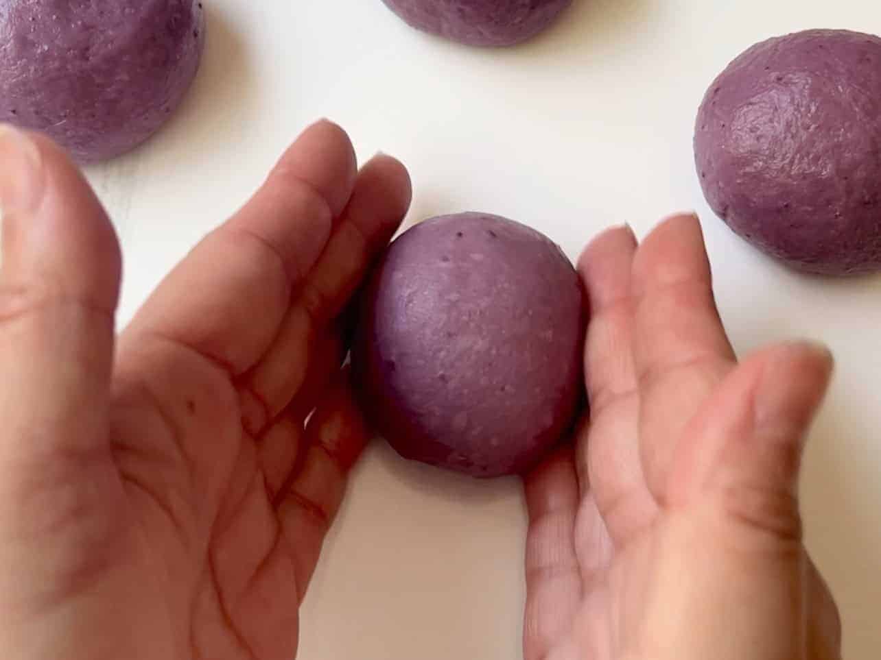 rolling ube coconut dough to equal dough balls