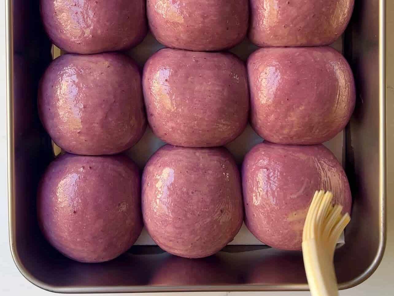 brush on coconut milk/egg wash to ube coconut dough before baking