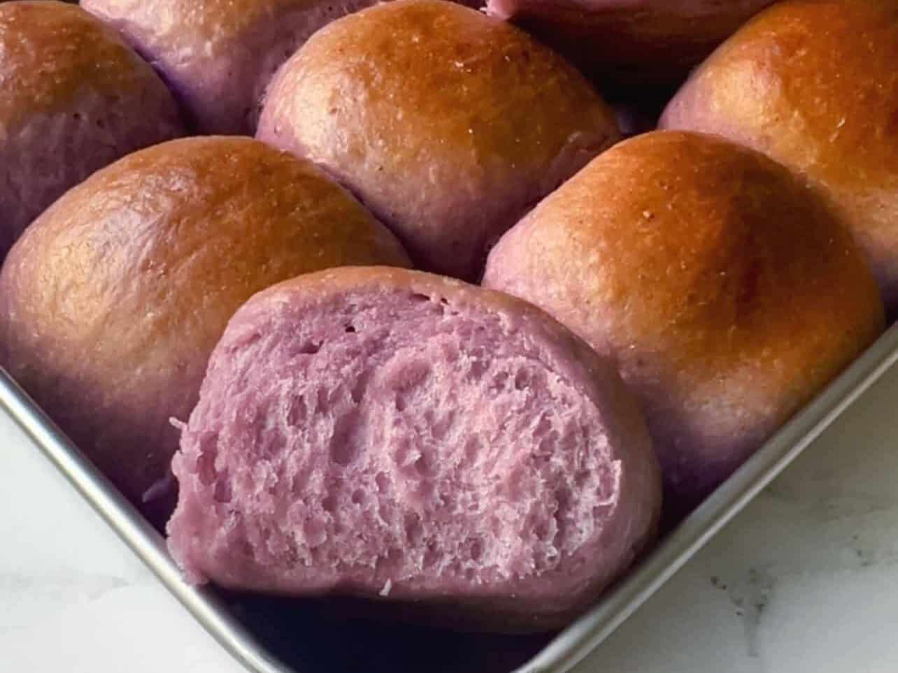 purple ube coconut sweet rolls baked and ready to enjoy in baking pan