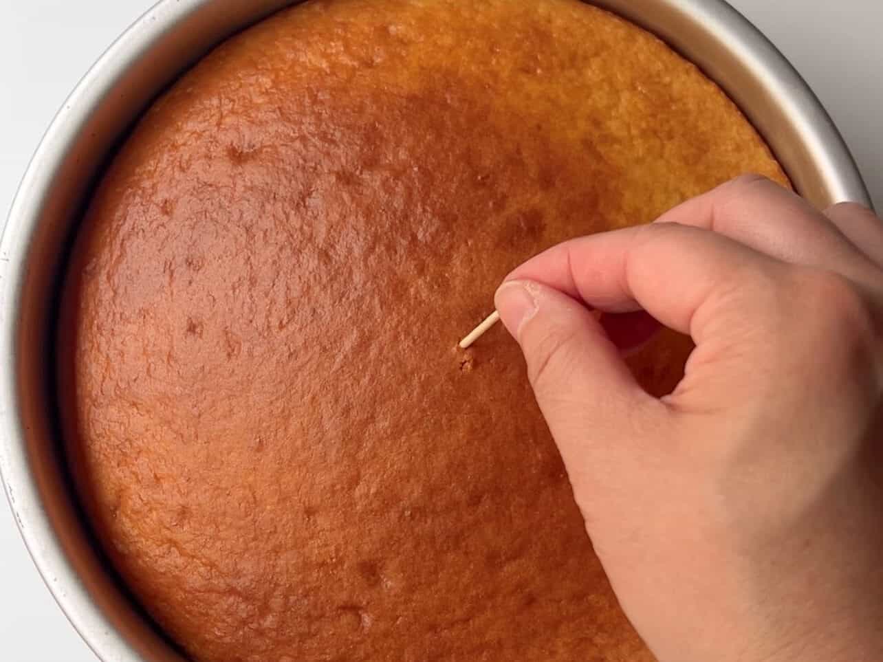 using the toothpick method to check cake doneness