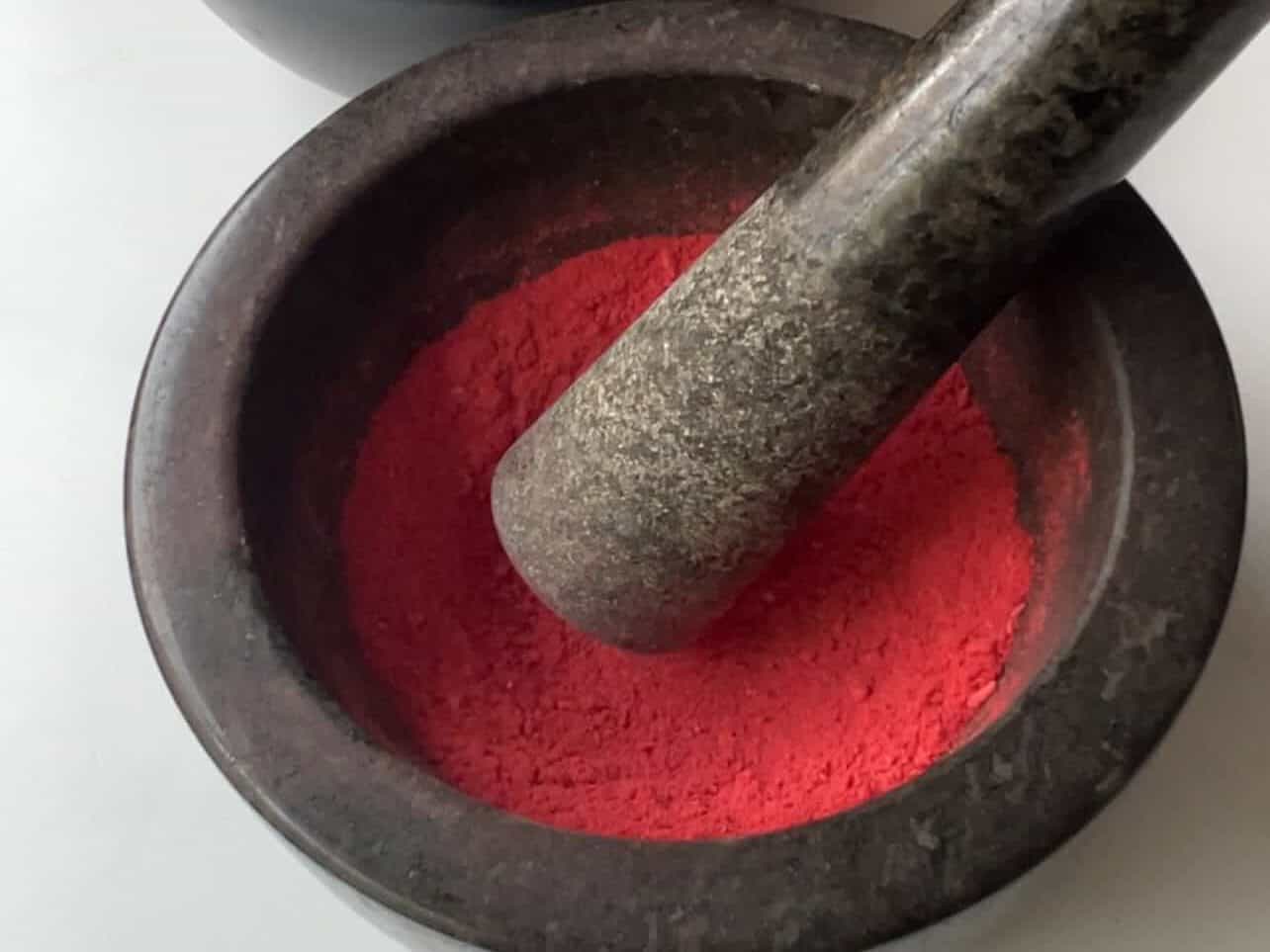 crush freeze-dried strawberries in a mortar and pestle