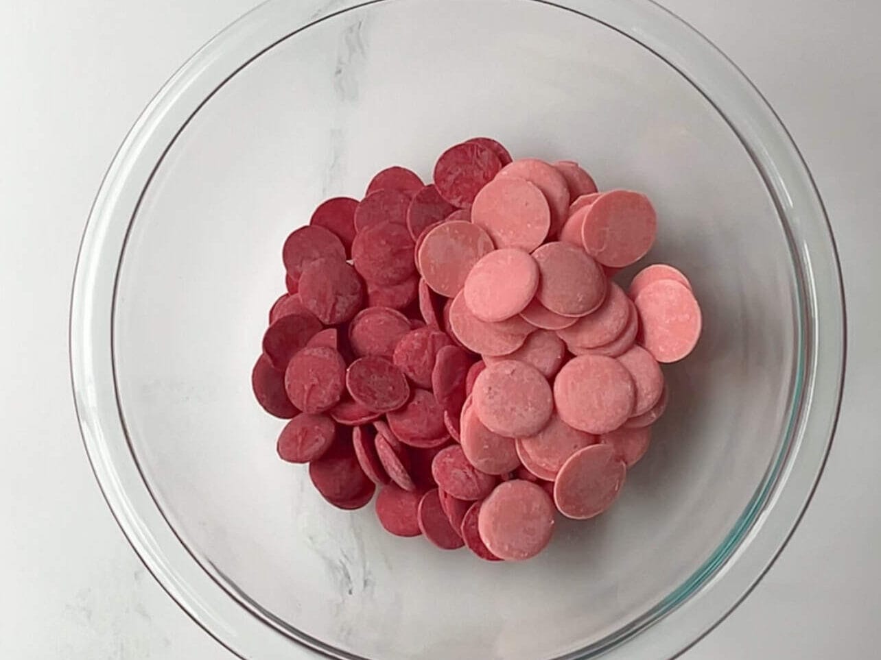 red and strawberry crème candy melts in a glass bowl ready to melt